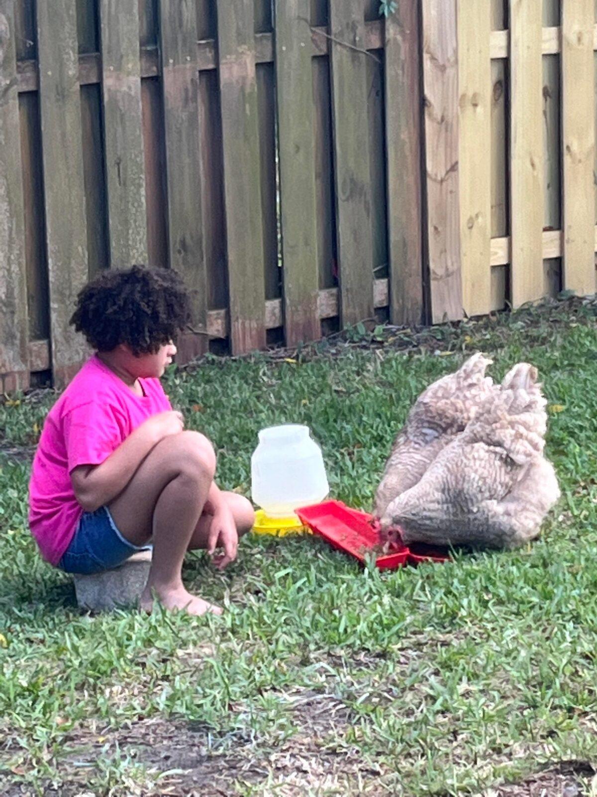 Kathy Beyer's adopted daughter, Elysia, who had been severely traumatized in the foster care system, finds calm and peace when she's with her chickens. (Courtesy of Kathy Beyer)