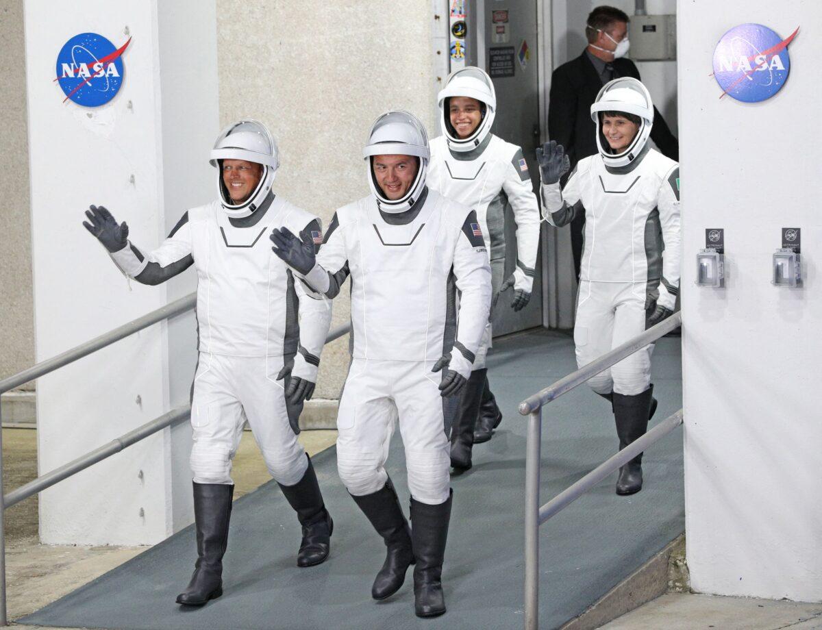 (L–R) Crew-4 mission astronauts Bob Hines, Kjell Lindgren, Jessica Watkins, and Samantha Cristoforetti of the European Space Agency walk out of the Neil A. Armstrong Operations and Checkout Building en route to launch complex 39A at the Kennedy Space Center in Florida on April 27, 2022. (Gregg Newton/AFP via Getty Images)