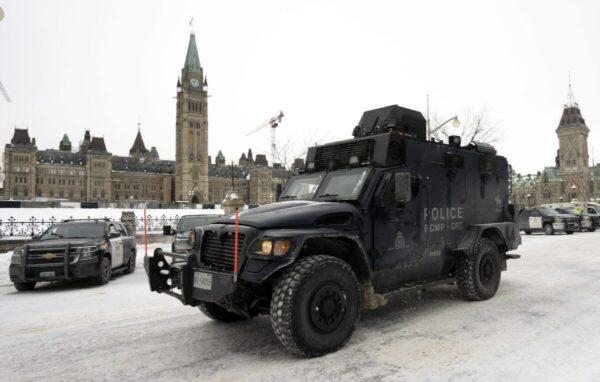 An RCMP tactical vehicle drives past the Parliament Buildings after a massive police operation quelled the Freedom Convoy protest in Ottawa, on Feb. 20, 2022. (The Canadian Press/Adrian Wyld)