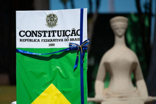 Supporters of Brazilian President Jair Bolsonaro with the Brazilian Constitution during a motorcade and demonstration in favor of the government and against the Supreme Court amidst the coronavirus pandemic in front Supreme Court in Brasilia, Brazil, on May 31, 2020. (Andressa Anholete/Getty Images)