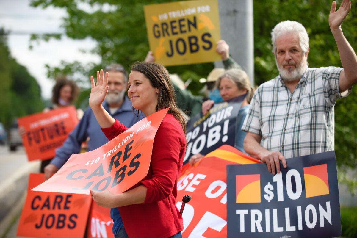 Demonstrators from the Sierra Club, Workers For Progress, Our Revolution, and the Chesapeake Climate Action Network picket in front of the office of U.S. Senator Shelley Moore Capito (R-W.Va.) in Morgantown, West Va., on June 3, 2021. (Jeff Swensen/Getty Images for Green New Deal Network)