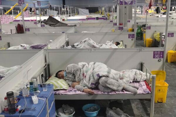 Residents rest at a temporary hospital converted from the National Exhibition and Convention Center to quarantine COVID-positive people in Shanghai, China, on April 18, 2022. (Chinatopix via AP)