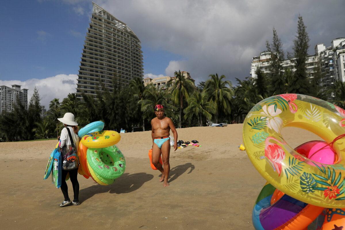 Vendors sell swimming accessories on Sanya Bay beach in Sanya, Hainan Province, China, on Nov. 26, 2020. (Tingshu Wang/Reuters)