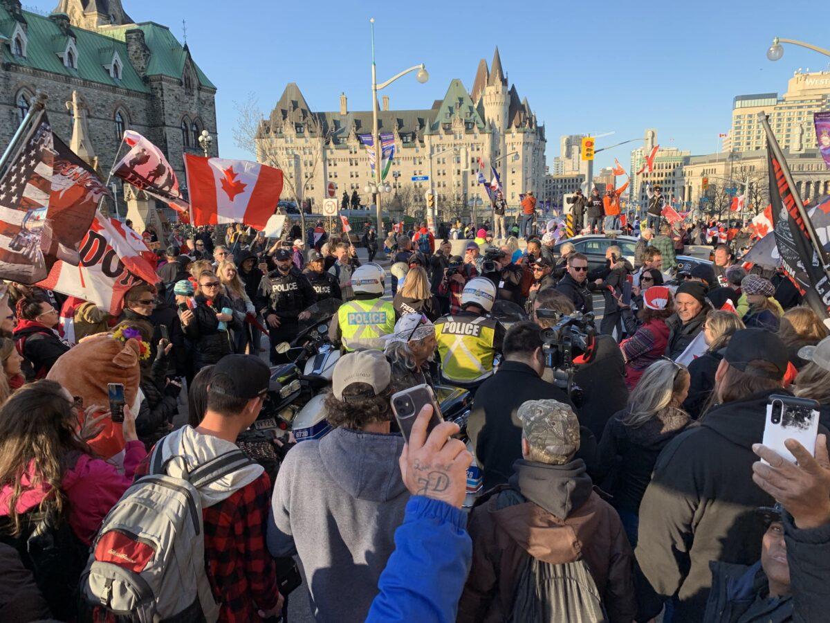 Protesters gather near Parliament Hill as they prepare to start their march along Wellington St. in Ottawa on April 29, 2022. (Jonathan Ren/The Epoch Times)