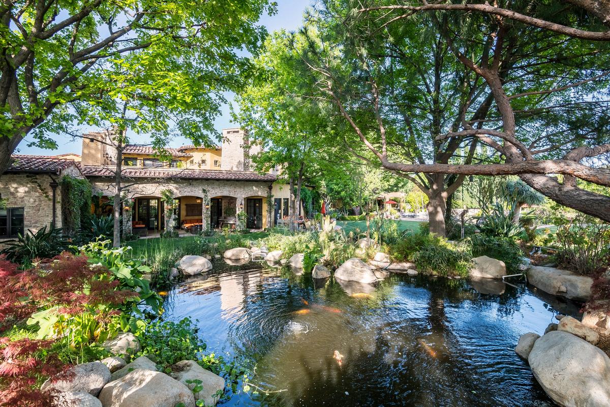 Outside is a veritable paradise in a California landscape. Here you see the pond, some of the terraces, shade trees, and the beautifully landscaped grounds. (Jade Mills)