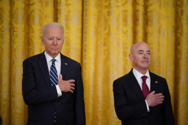 U.S. President Joe Biden (L) and Homeland Security Alejandro Mayorkas (R) take part in a naturalization ceremony for new citizens ahead of Independence Day in the East Room of the White House in Washington on July 2, 2021. (Mandel Ngan/AFP via Getty Images)