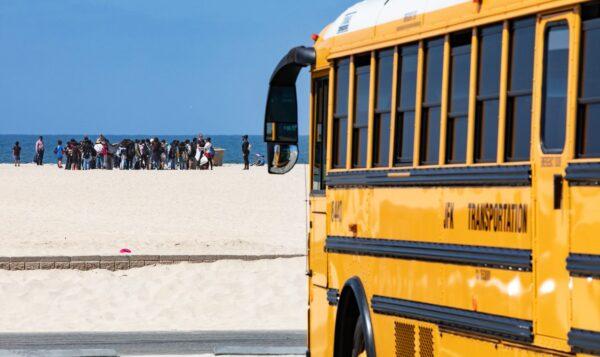 Elementary school students celebrating Kids Ocean Day work together in cleaning Huntington State Beach in Huntington Beach, Calif., on May 31, 2022. (John Fredricks/The Epoch Times)