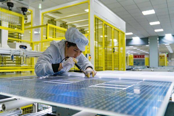 An employee works on the production line of solar panels for orders from India at a factory of GCL (Group) Holding Co., Ltd in Hefei, Anhui Province of China on Jan. 5, 2022. (Ruan Xuefeng/VCG via Getty Images)