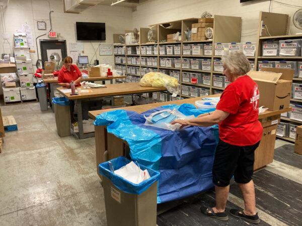 Two volunteers prepare medical supplies for shipment to Ukraine on April 19 at Project CURE Phoenix in Arizona. (Allan Stein/The Epoch Times)