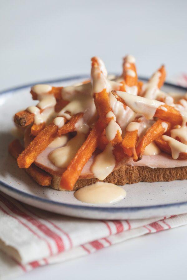 A horseshoe sandwich, consisting of toasted bread, ham, French fries, and cheese sauce. The dish originated in Springfield, Ill. (United We Eat)