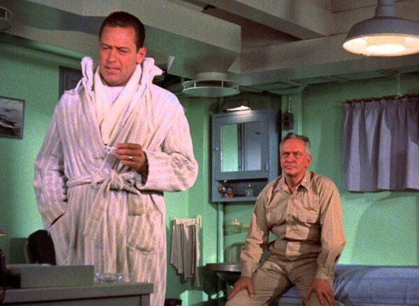 William Holden (L) as Lt. Harry Brubaker has a talk with Fredric March as Rear Adm. George Tarrant in “The Bridges at Toko-Ri.” (Paramount Pictures)