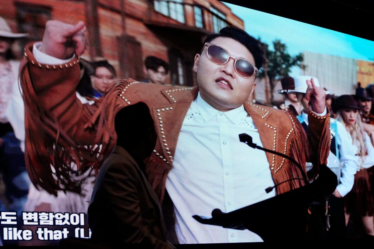South Korean singer PSY watches his new music videos during a press conference to unveil his ninth full-length studio album titled "PSY 9th." in Seoul, South Korea, on April 29, 2022. (Ahn Young-joon/AP Photo)