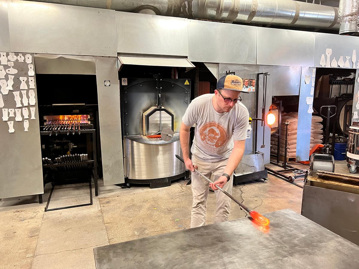 Pretentious Craft, a hybrid glassblowing studio and craft beer brewery, produces both handmade beer and beautiful glassware. Here, owner—and glass artist and brewer—Matthew Cummings gives a live glassblowing demonstration for several patrons. (Mary Ann Anderson/TNS)