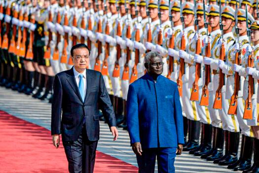 Solomon Islands Prime Minister Manasseh Sogavare and Chinese Premier Li Keqiang inspect honour guards during a welcome ceremony at the Great Hall of the People in Beijing on Oct. 9, 2019. (Wang Zhao/AFP via Getty Images)