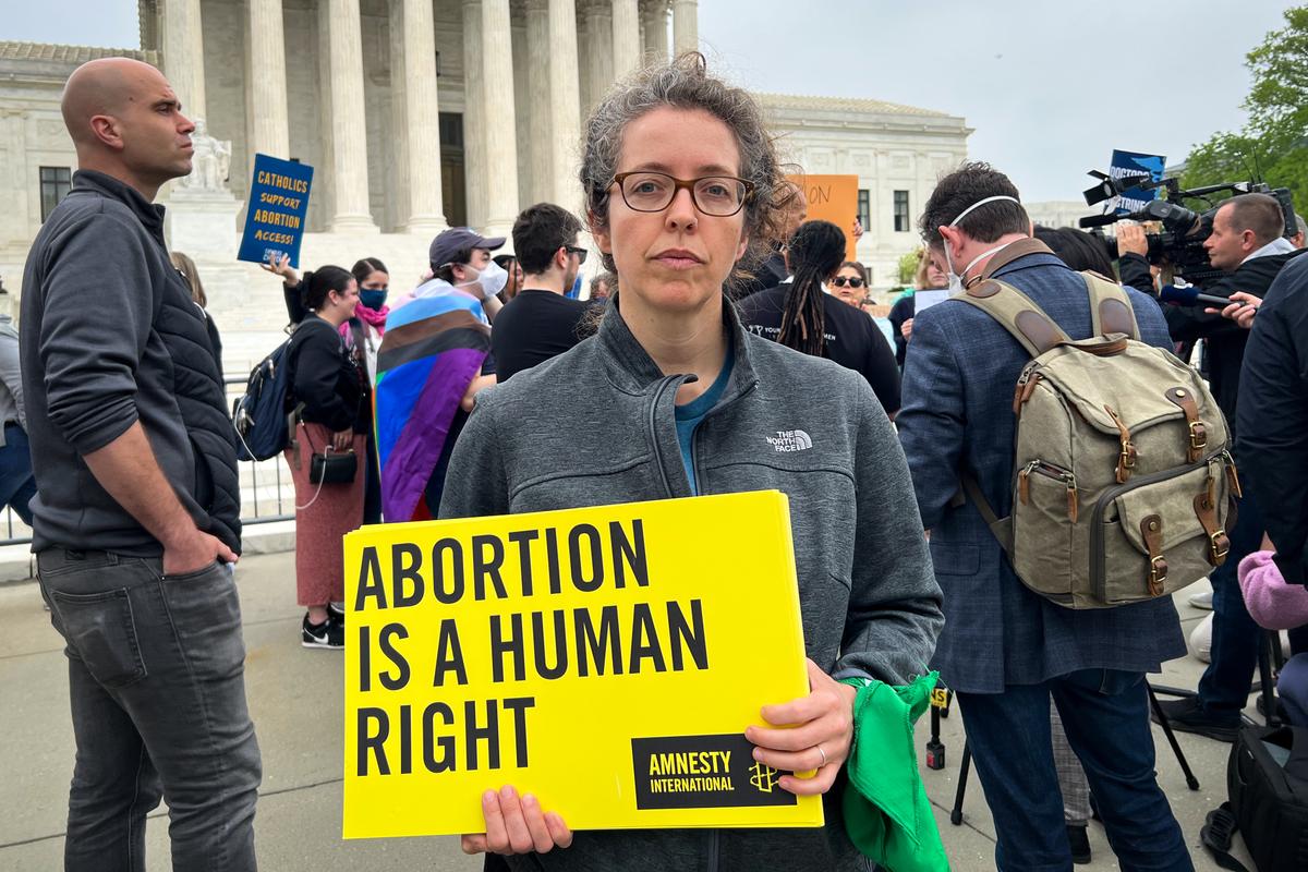 Tarah Demant, a director at Amnesty International is among the protesters gathered outside of the Supreme Court building in Washington, on May 3, 2022. (Emel Akan/The Epoch Times)