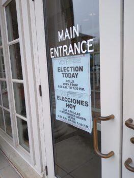 A sign on the front door of Westlake (Ohio) City Hall reminds those entering that it is election day. A poll manager in the west Cleveland suburb said voter turnout had been slow. (Michael Sakal/The Epoch Times)