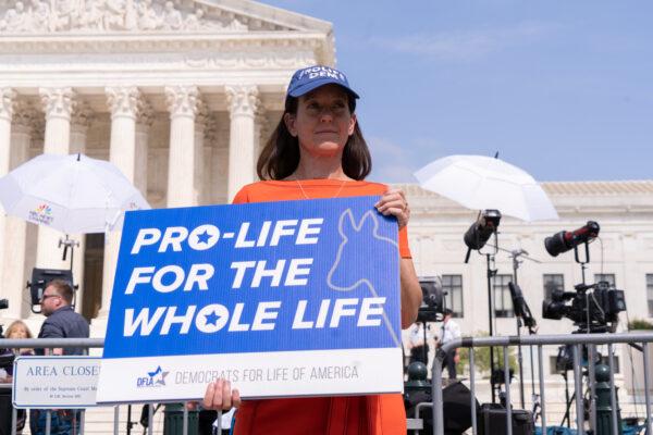 Activists protest in response to the leaked Supreme Court draft decision to overturn Roe v. Wade in front of the U.S. Supreme Court in Washington D.C., May 3, 2022. (Louis Chen/The Epoch Times)