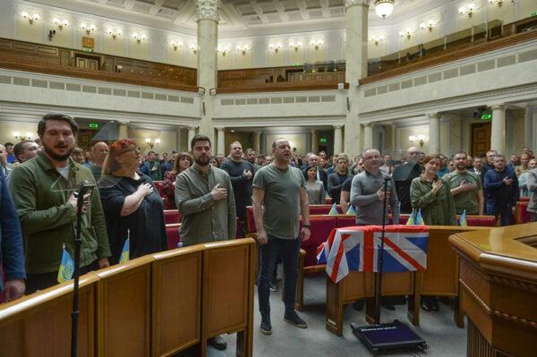 Ukrainian MPs stand for the national anthem before UK Prime Minister Boris Johnson’s address to the Ukrainian Parliament in Kyiv, on May 3, 2022. (Verkhovna Rada/PA Media)