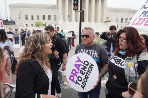 A pro-abortion protestor shouts at pro-life protestor Bryan Kemper (center) before the U.S. Supreme Court in Washington, D.C., on May 4, 2022. (Jackson Elliott/The Epoch Times)