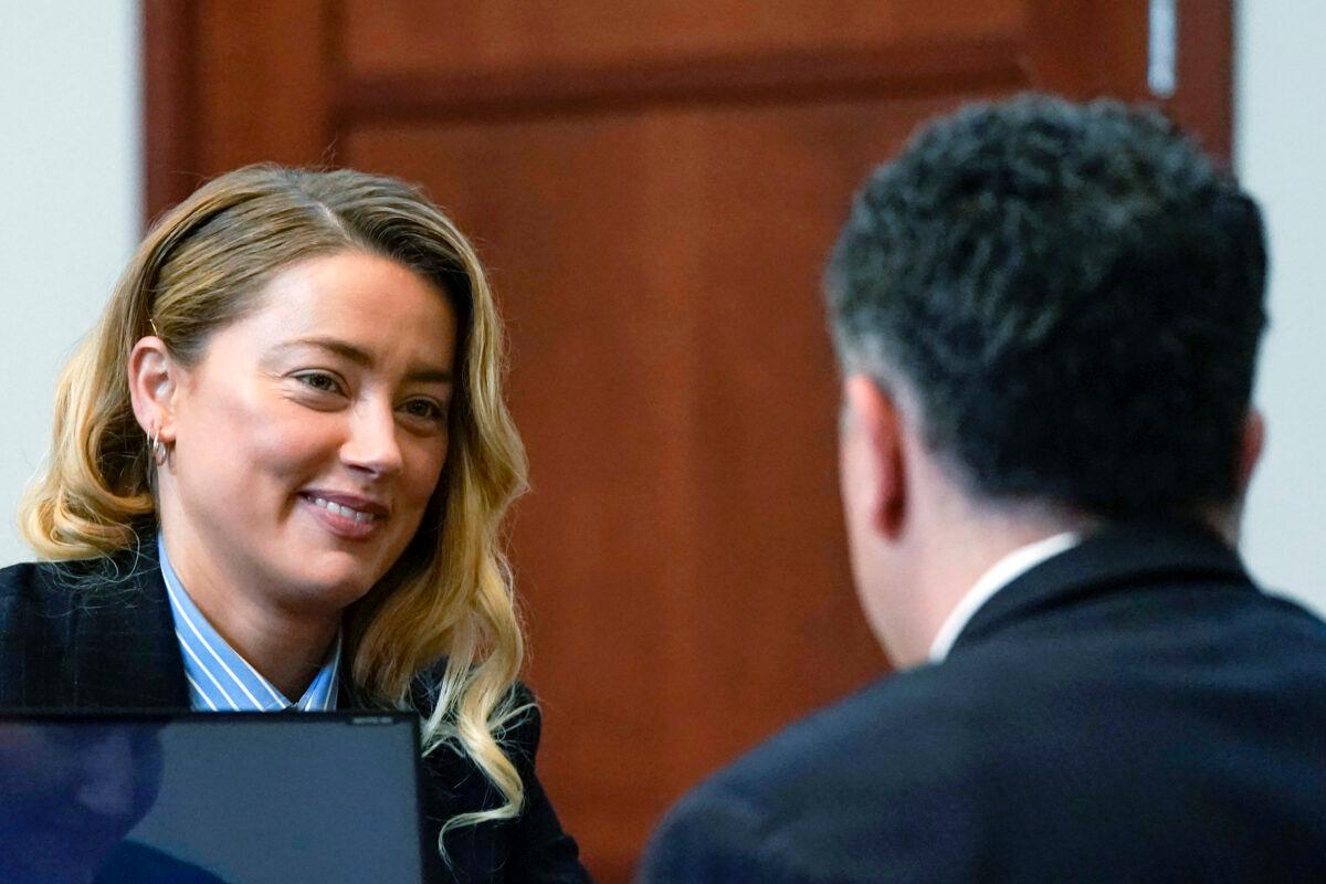 Actress Amber Heard (L) speaks with her attorney in the courtroom at the Fairfax County Circuit Court in Fairfax, Va., on May 4, 2022. (Elizabeth Frantz/Pool Photo via AP)