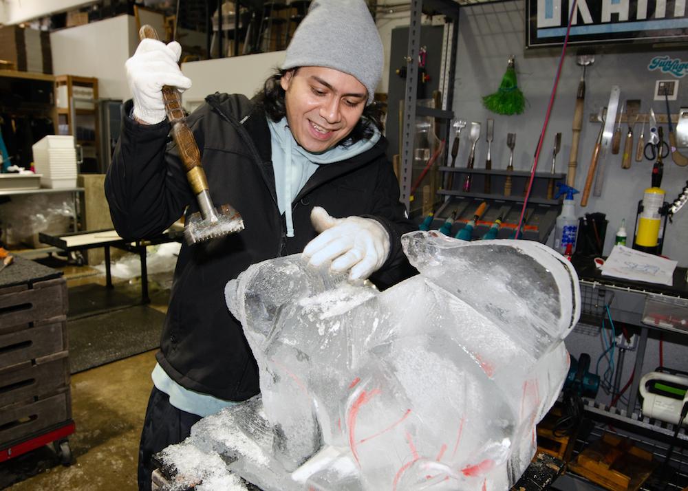 Ice carver Christian Lopez sculpts the likeness of a client’s dog at Okamoto Studio, in Queens, N.Y. (Dave Paone/The Epoch Times)