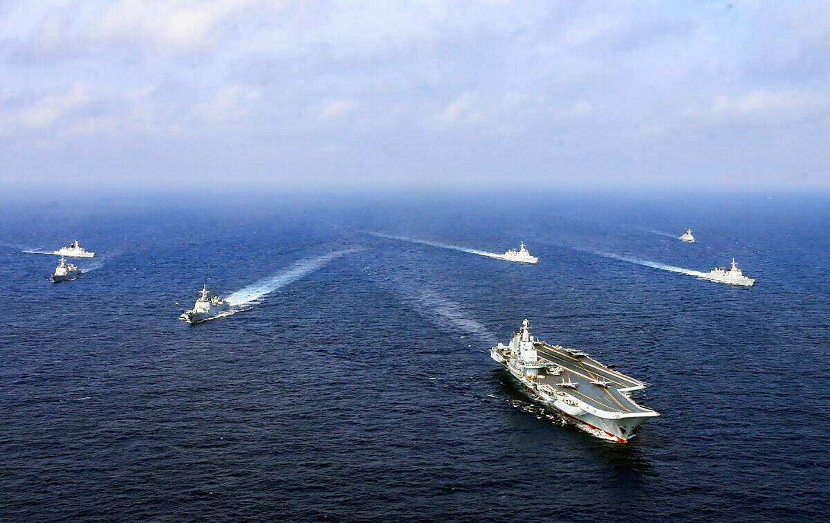 China's sole operational aircraft carrier, the Liaoning (front), sails with other ships during a drill at sea in April 2018. (AFP via Getty Images)