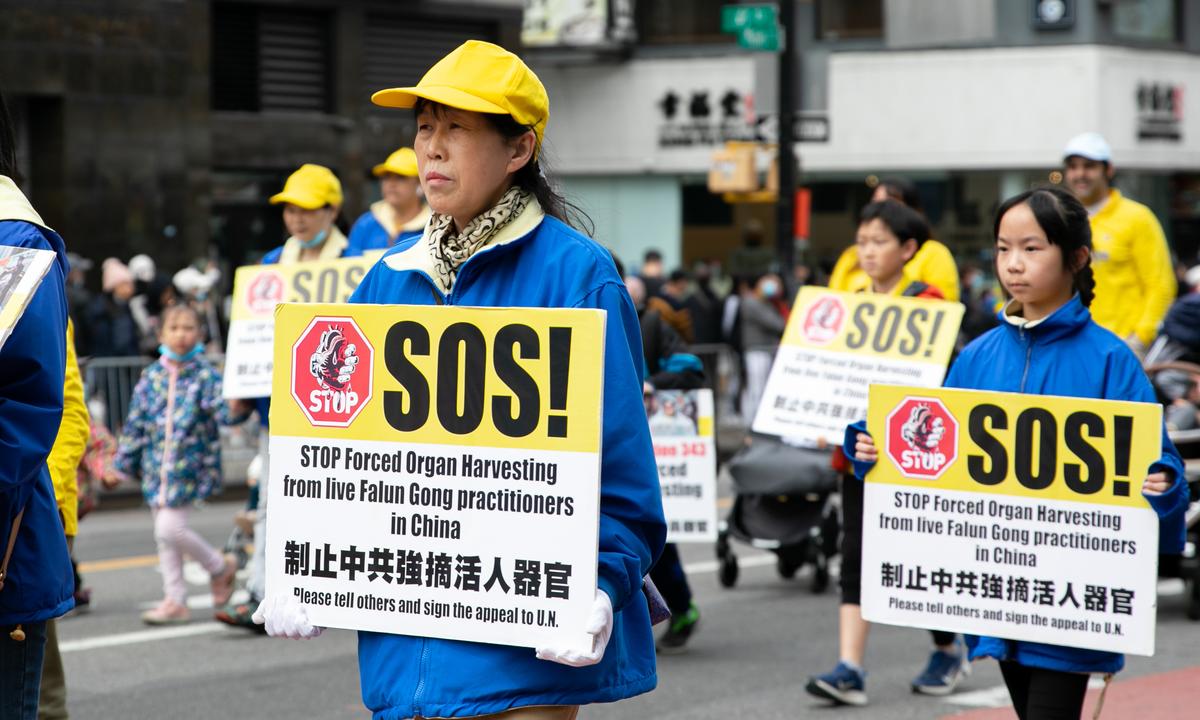 Falun Gong practitioners participate in a parade to commemorate the 23rd anniversary of the April 25th peaceful appeal of 10,000 Falun Gong practitioners in Beijing, in Flushing, N.Y., on April 23, 2022. (Chung I Ho/The Epoch Times)