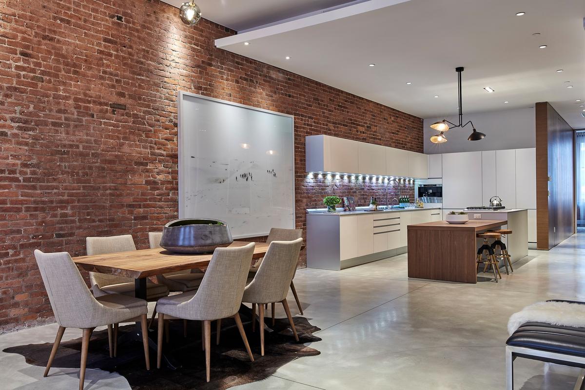 An exposed brick wall is preserved and highlighted in this industrial kitchen space. (Scott Gabriel Morris/TNS)