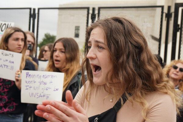 A pro-abortion protester shouts at pro-life protesters outside the U.S. Supreme Court on May 5, 2022. (Jackson Elliott/The Epoch Times)