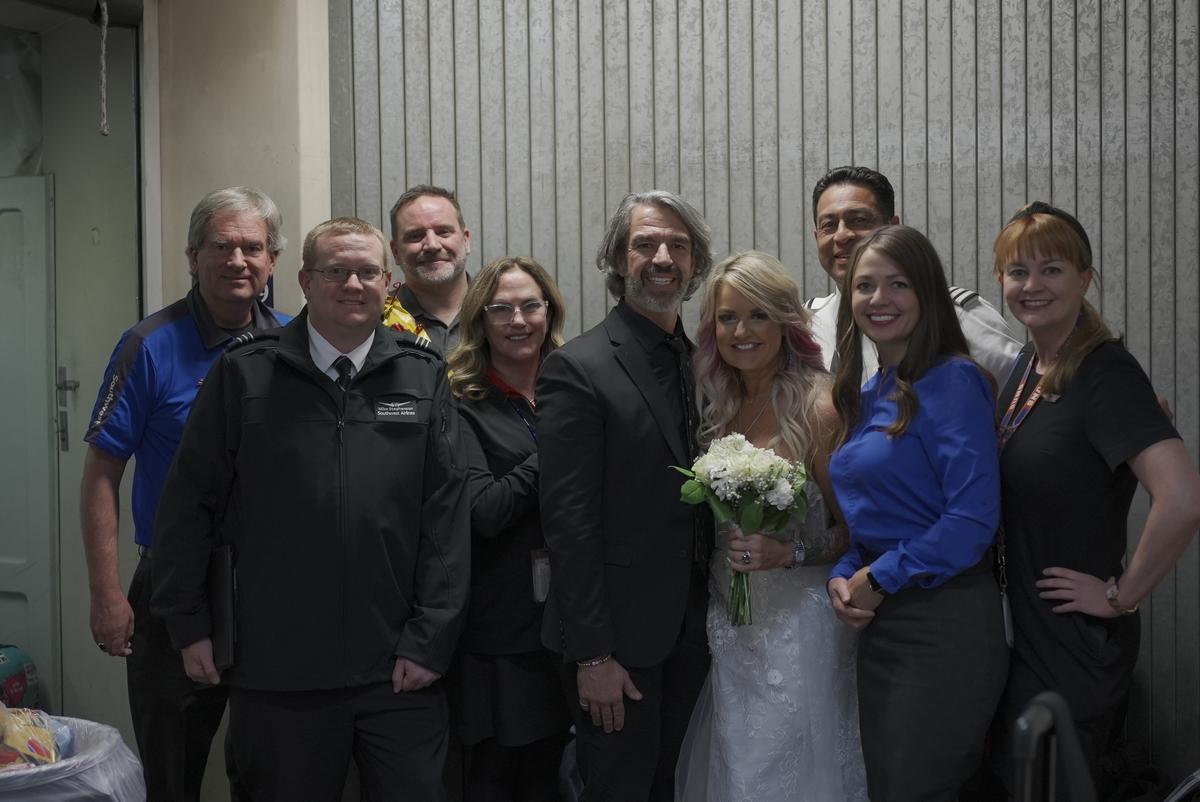 The newlyweds with the flight crew. (Courtesy of Chris Mitcham)