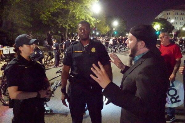 Pastor Mark Lee Dickson argues with police officers in front of the Supreme Court on May 4, 2022. (Jackson Elliott/The Epoch Times)