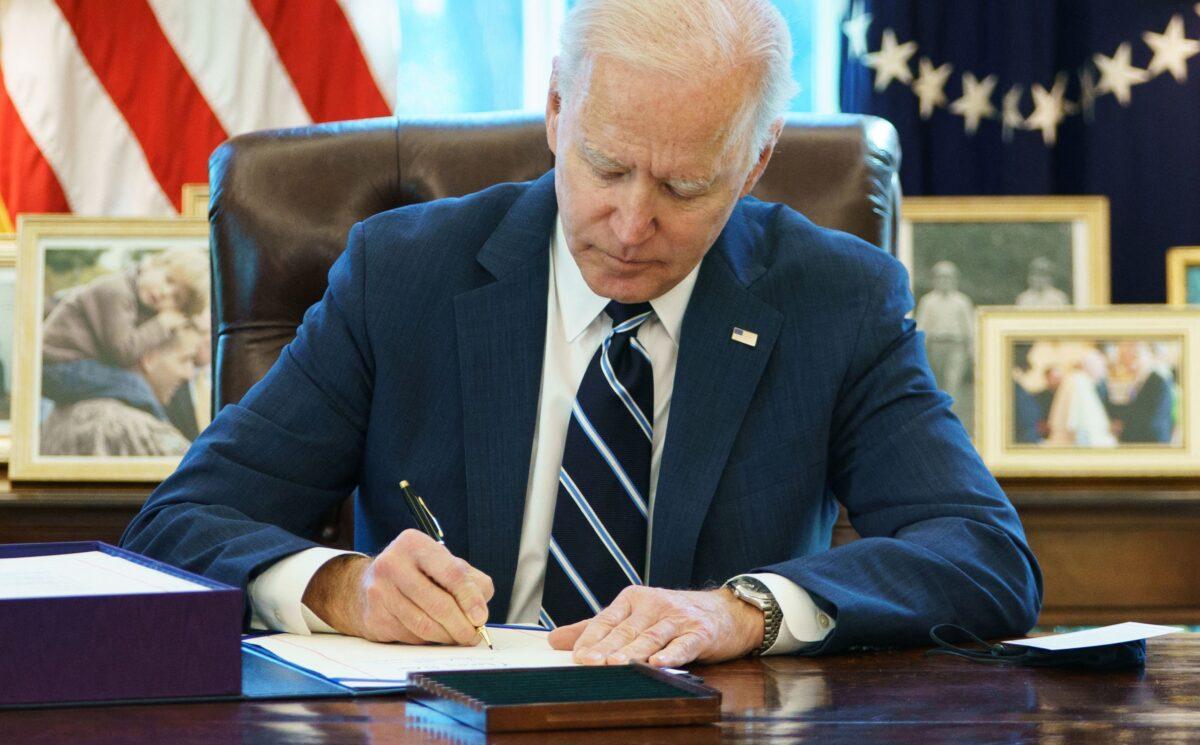 President Joe Biden signs the American Rescue Plan in the Oval Office of the White House in Washington on March 11, 2021. (Mandel Ngan/AFP/Getty Images)