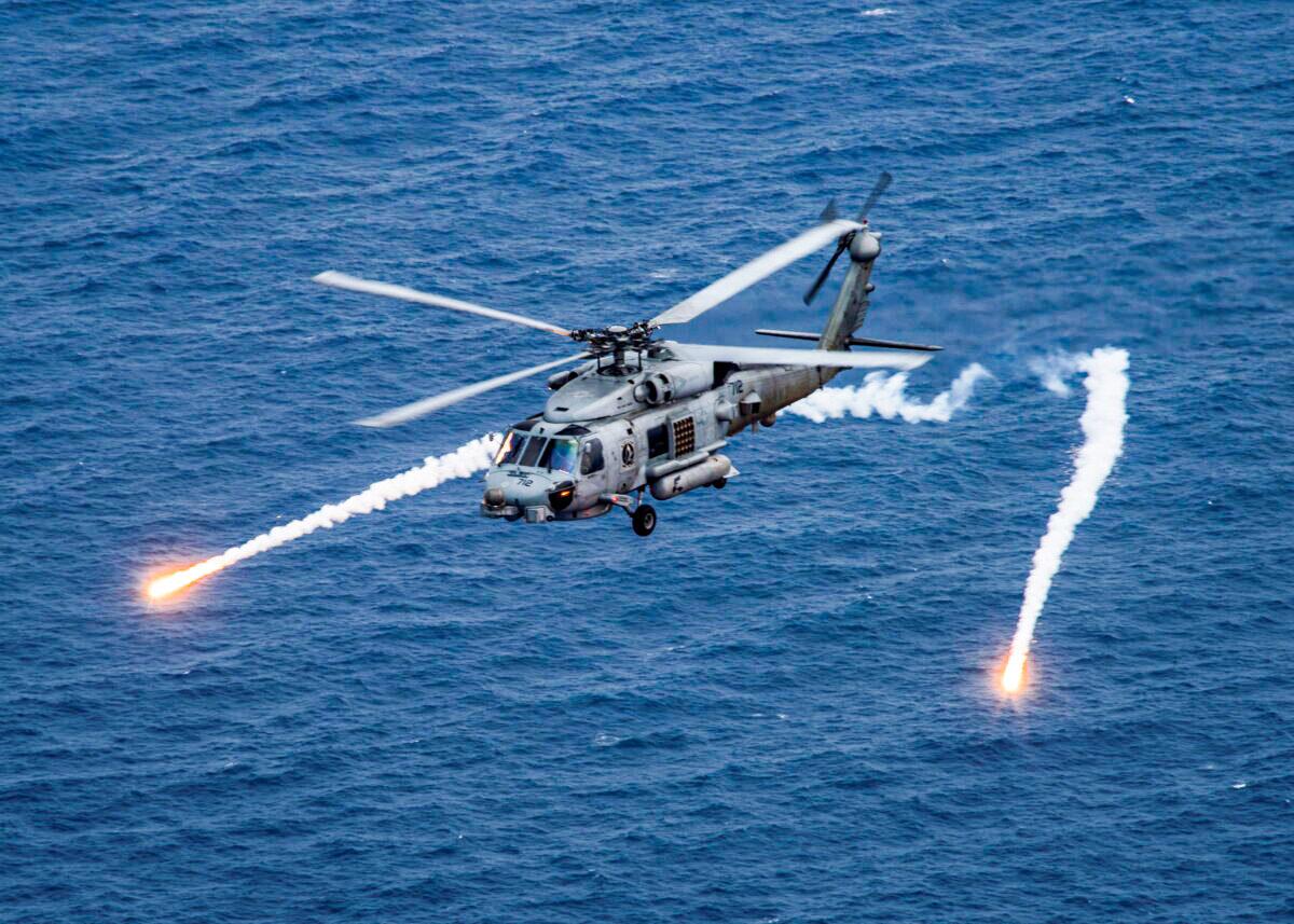 A U.S. Navy MH-60R Sea Hawk helicopter from the "Blue Hawks" of Helicopter Maritime Strike Squadron 78 fires chaff flares during a training exercise near the aircraft carrier USS Carl Vinson in the Philippine Sea on April 24, 2017. (U.S. Navy/Mass Communication Specialist 2nd Class Sean M. Castellano/Handout via Reuters)