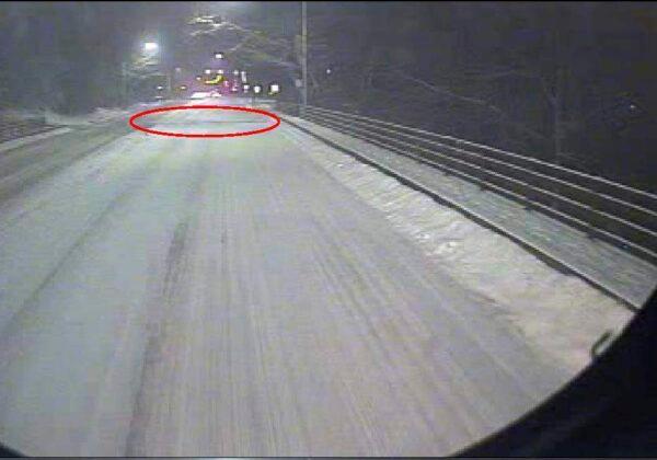 The National Transportation Safety Board (NTSB) says this image is from the forward-facing camera on the bus that was involved in the collapse of the Fern Hollow Bridge in Pittsburgh and shows the bridge deck separating at the east expansion joint (the red oval highlights the expansion joint). (National Transportation Safety Board via AP)
