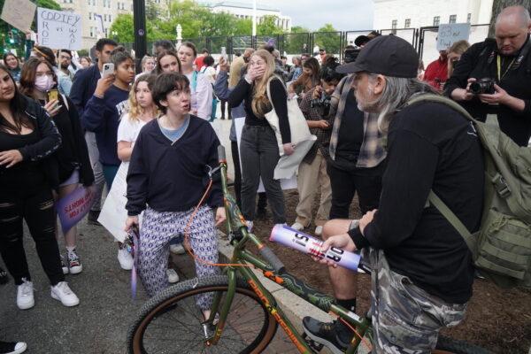 A pro-abortion protester screams at pro-life protestor Joe Green outside the Supreme Court on May 5, 2022. (Jackson Elliott/The Epoch Times)