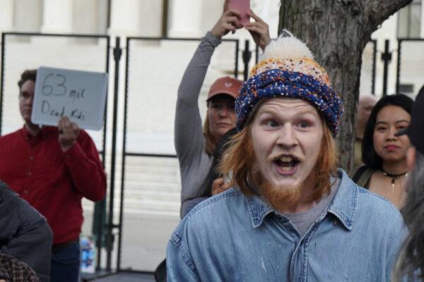  Pro-abortion protester Joseph Price screams at pro-life protestor Joe Green outside the Supreme Court on May 5, 2022. (Jackson Elliott/The Epoch Times)