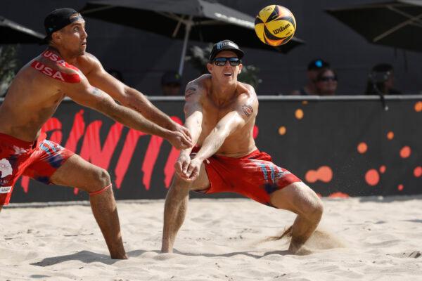 Tri Bourne and Trevor Crabb both go for the ball during the men's final match against Chase Budinger and Casey Patterson at the AVP Gold Series Manhattan Beach Open, in Manhattan Beach, Calif., on August 22, 2021. (Joe Scarnici/Getty Images)