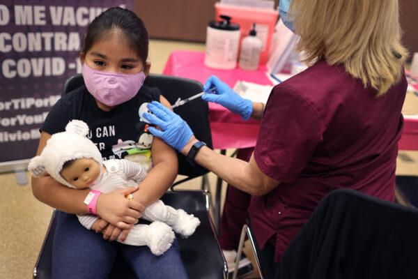 First-grade student, seven-year-old Rihanna Chihuaque, receives a covid-19 vaccine at Arturo Velasquez Institute in Chicago, Ill., on Nov. 12, 2021. (Scott Olson/Getty Images)