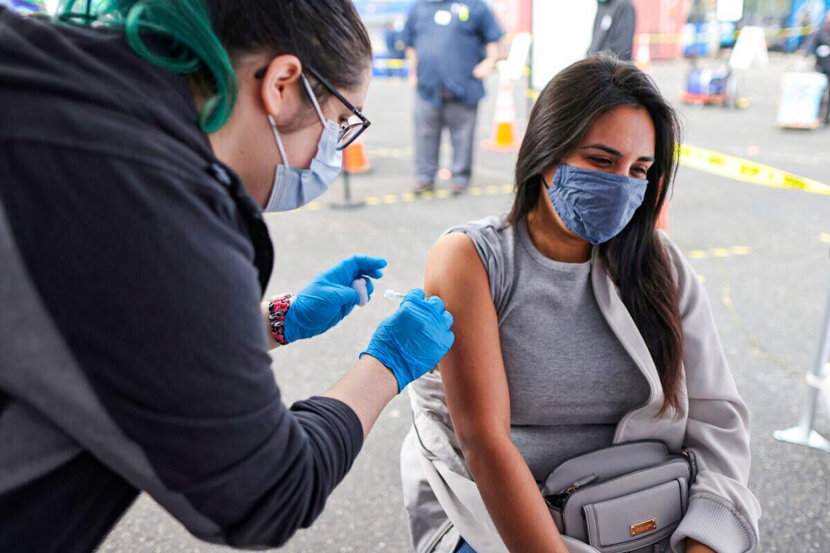 A woman receives a COVID-19 vaccine in Los Angeles on March 25, 2021. (Lucy Nicholson/Reuters)