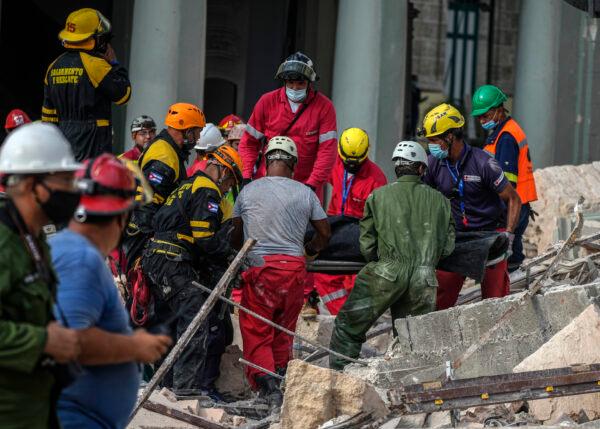 Rescue teams recover a body at the site of a deadly explosion that destroyed the five-star Hotel Saratoga, in Havana, Cuba, on May 6, 2022. (Ramon Espinosa/AP Photo)