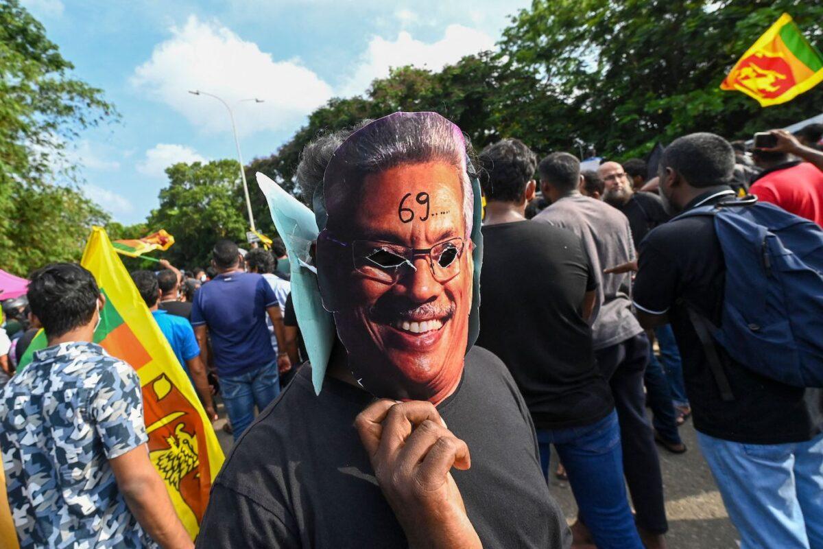 A demonstrator wearing a mask of Sri Lankan President Gotabaya Rajapaksa takes part in a demonstration over the country's crippling economic crisis near the parliament building in Colombo, Sri Lanka, on May 6, 2022. (Ishara S. Kodikara/AFP via Getty Images)