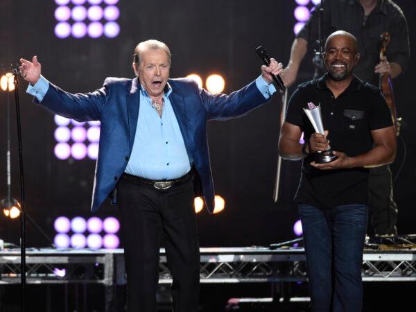 Mickey Gilley accepts the triple crown award at ACM Presents Superstar Duets at Globe Life Park in Arlington, Texas, on April 17, 2015. (Chris Pizzello/Invision/AP)