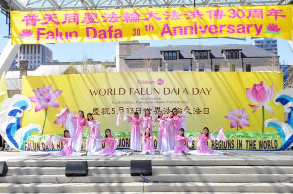 Falun Gong adherents commemorated the 30th anniversary of the spreading of the practice with dance and music performances at the Toronto City Hall on May 7, 2022. (Allen Zhou/The Epoch Times)