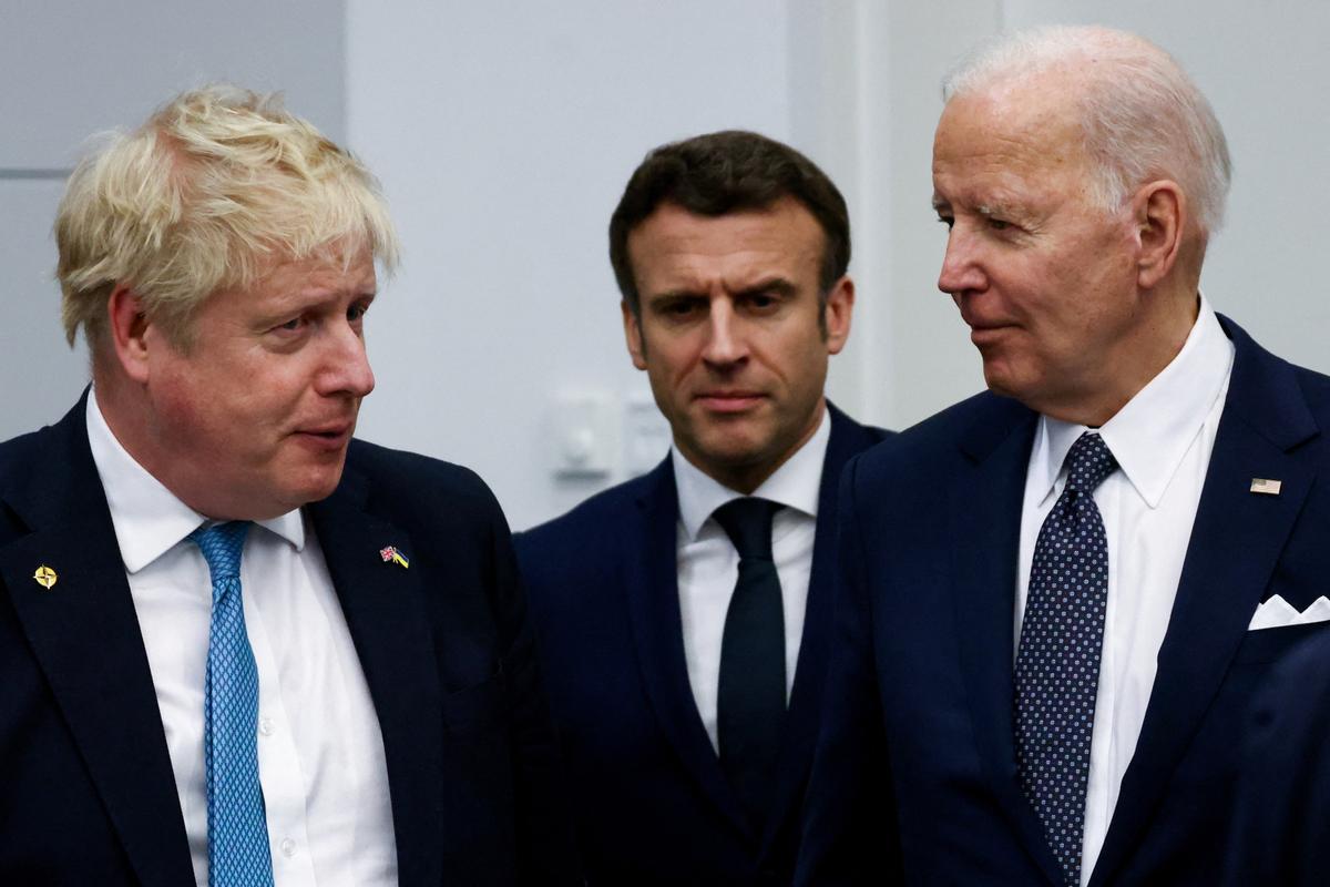 (L–R) British Prime Minister Boris Johnson, French President Emmanuel Macron, and U.S. President Joe Biden arrive for a G-7 leaders' family photo during a NATO summit on Russia's invasion of Ukraine at the alliance's headquarters in Brussels on March 24, 2022. (Henry Nicholls/Pool via Getty Images)