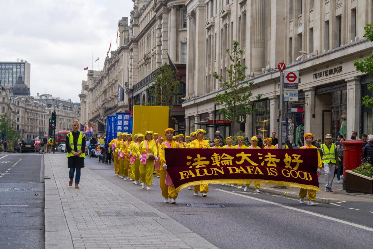 A parade in celebration of World Falun Dafa Day passes through the streets of central London on May 7, 2022. (Yan Ning/Epoch Times)