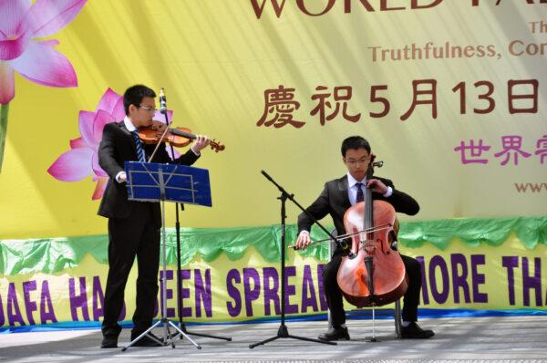 Falun Gong adherents commemorated the 30th anniversary of the spreading of the practice with dance and music performances at the Toronto City Hall on May 7, 2022. (Allen Zhou/The Epoch Times)