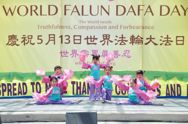 Falun Gong adherents commemorated the 30th anniversary of the spreading of the practice with dance and music performances at the Toronto City Hall on May 7, 2022. (Allen Zhou/The Epoch Times)