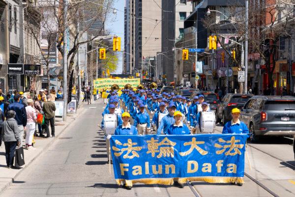 Falun Gong adherents paraded through downtown Toronto on May 7, 2022, in commemoration of the 30th anniversary of the spreading of the practice around the world. (Evan Ning/The Epoch Times)