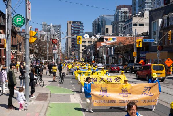 Falun Gong adherents paraded through downtown Toronto on May 7, 2022, in commemoration of the 30th anniversary of the spreading of the practice around the world. (Evan Ning/The Epoch Times)
