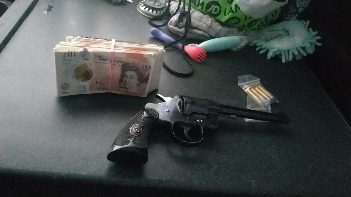 An image of a gun and a wad of notes sent on the EncroChat network in March 2020. (Metropolitan Police)